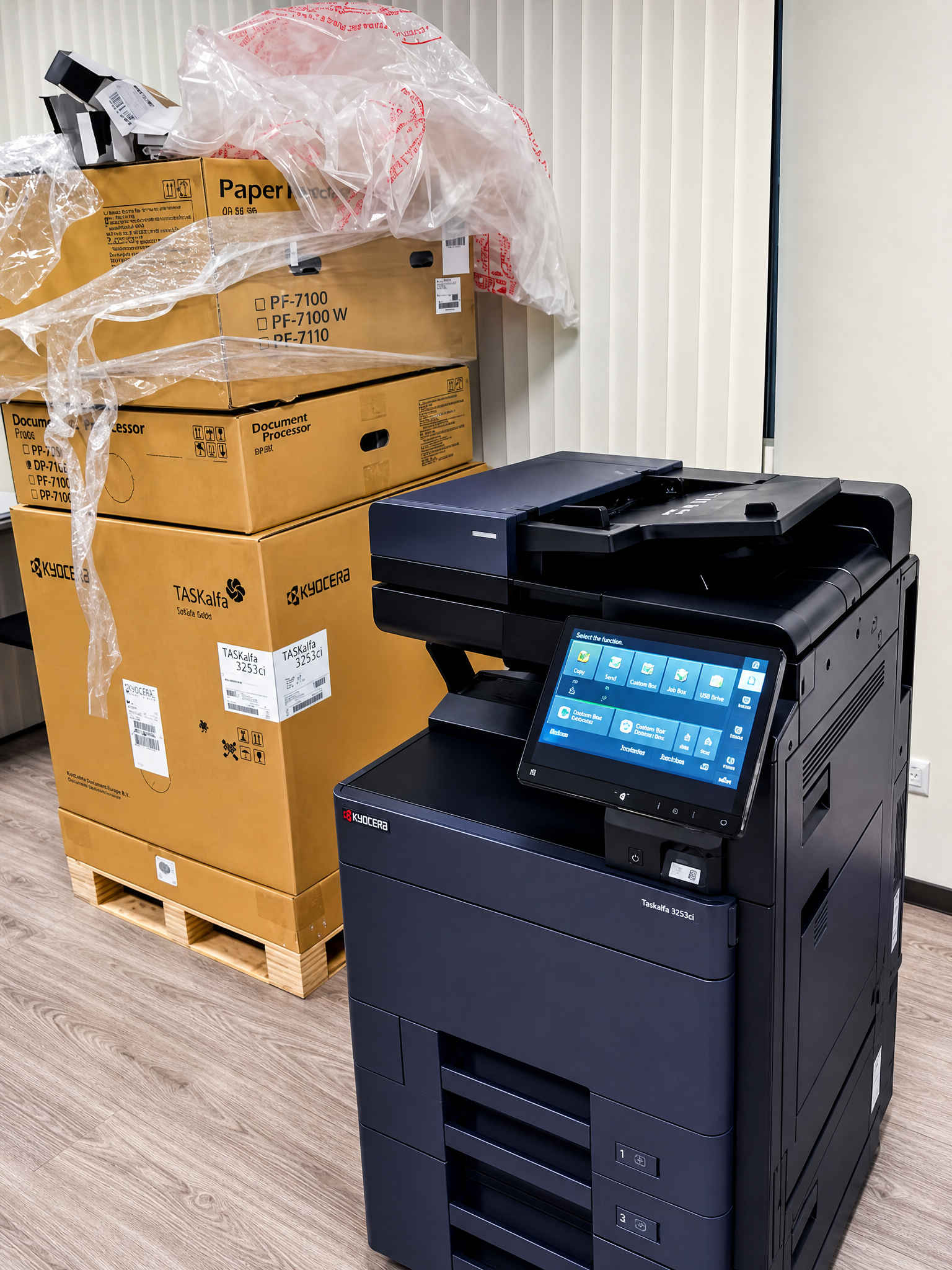 МФУ Kyocera TASKalfa 3253ci в офисе рядом с коробками запчастей
